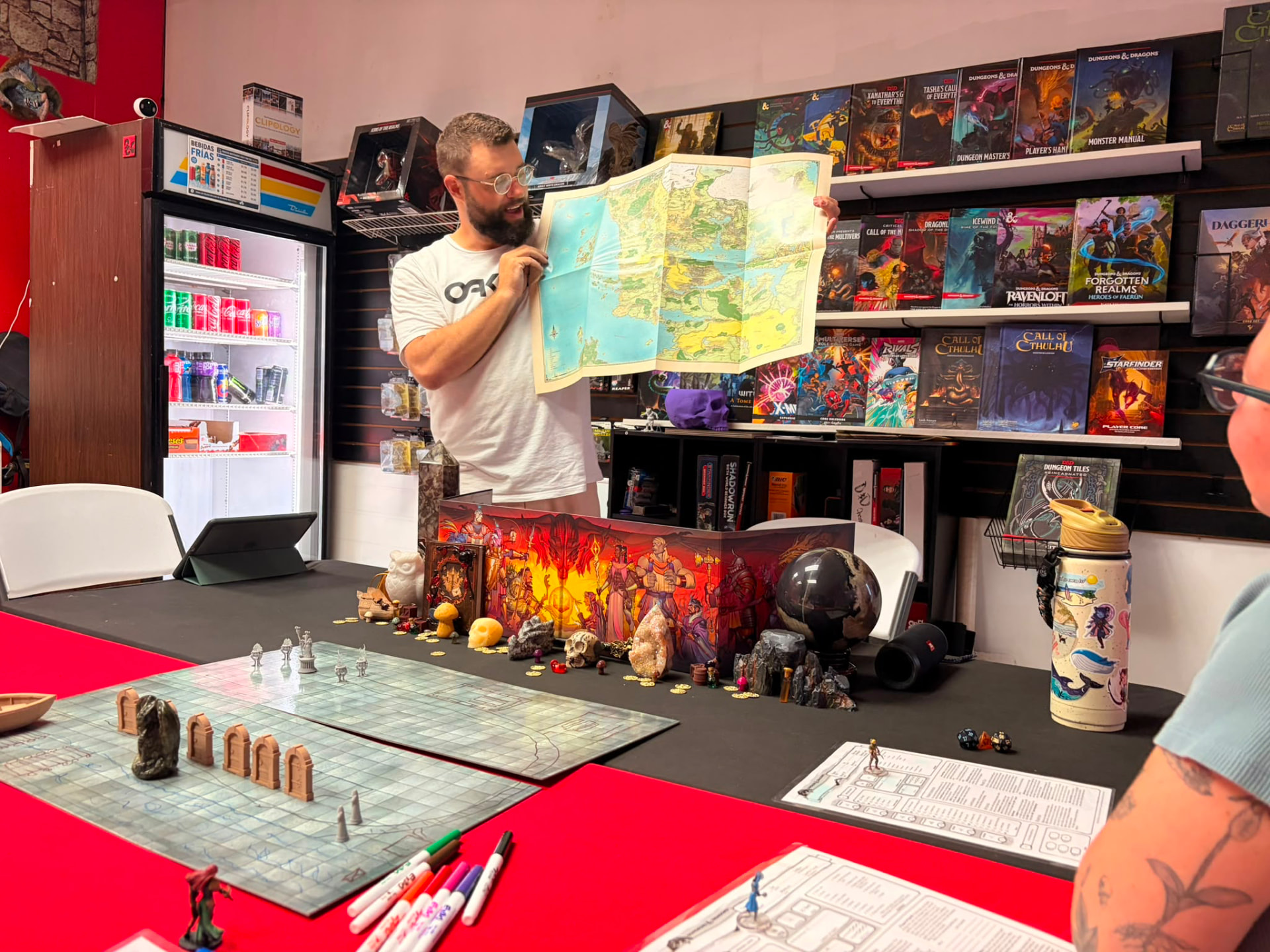 Battlehammer's Dungeon store interior with RPG shelves, battle map, and miniatures